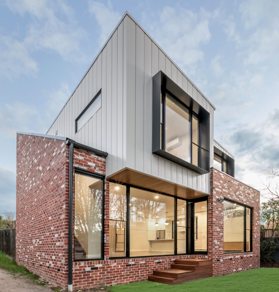 Heritage home extension in Hawthorn Melbourne. Recycled red bricks on ground floor and architectural cladding on second storey extension with floor to ceiling windows